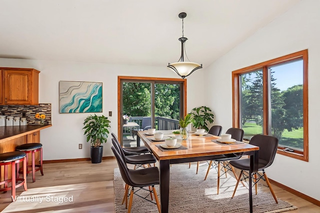 733 Meadow Dr, Hudson, WI 54016 - dining area with healthy amount of natural light, light wood-style flooring, and vaulted ceiling