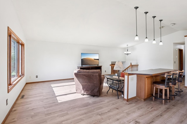 733 Meadow Dr, Hudson, WI 54016 - living room with vaulted ceiling, light wood-style floors, and a chandelier