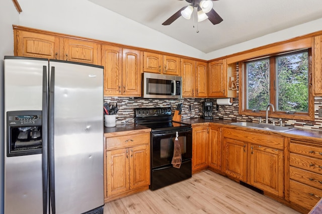 733 Meadow Dr, Hudson, WI 54016 - kitchen featuring stainless steel appliances, lofted ceiling, brown cabinetry, tasteful backsplash, and ceiling fan