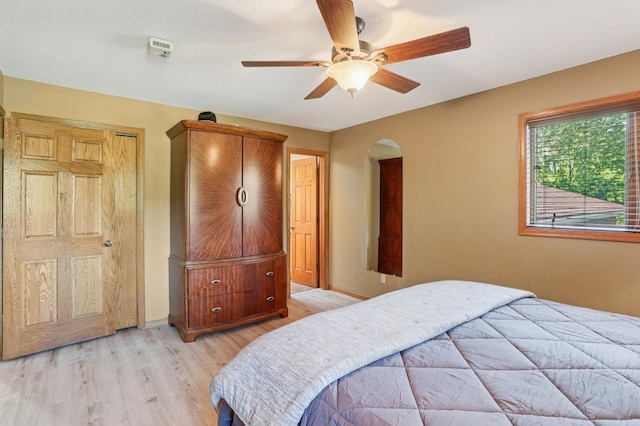 733 Meadow Dr, Hudson, WI 54016 - bedroom featuring light wood finished floors, arched walkways, and a ceiling fan