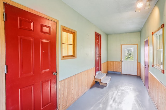 733 Meadow Dr, Hudson, WI 54016 - foyer with a wainscoted wall, finished concrete floors, and wood walls