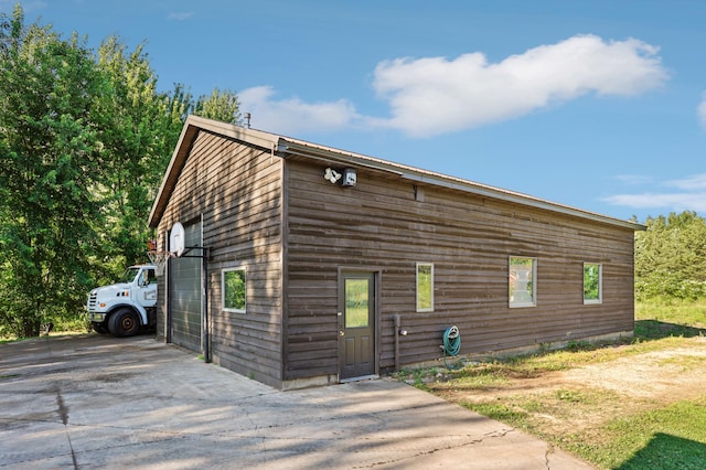 733 Meadow Dr, Hudson, WI 54016 - view of property exterior featuring driveway and an outbuilding