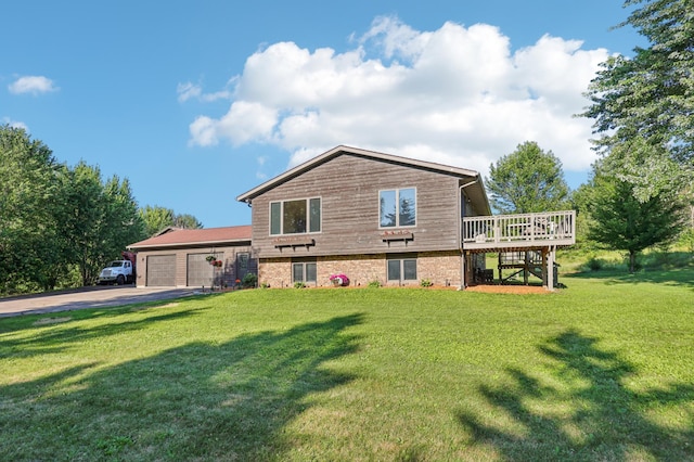 733 Meadow Dr, Hudson, WI 54016 - rear view of house with a garage, stairway, a deck, driveway, and a lawn