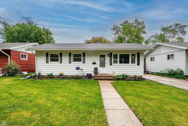 1124 15th St N, Moorhead, MN 56560 - ranch-style house with a front lawn and roof with shingles