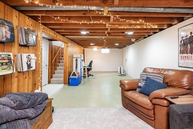 1124 15th St N, Moorhead, MN 56560 - living area with finished concrete flooring, stairway, and wooden walls