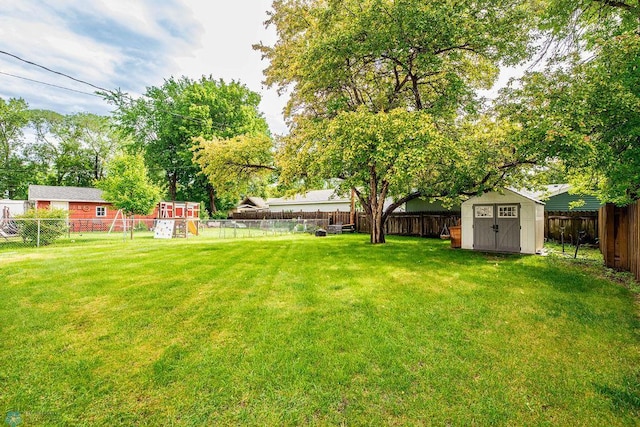 1124 15th St N, Moorhead, MN 56560 - fenced backyard featuring a storage unit and a playground