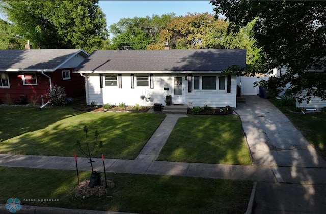 1124 15th St N, Moorhead, MN 56560 - ranch-style home with concrete driveway, a front yard, and a chimney