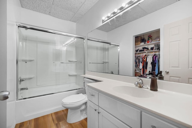 431 7th St Unit 2605, Minneapolis, MN 55415 - full bath featuring vanity, wood finished floors, enclosed tub / shower combo, a drop ceiling, and a walk in closet