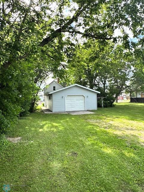 310 1st St SW, Mahnomen, MN 56557 - view of green lawn with an outbuilding and a garage