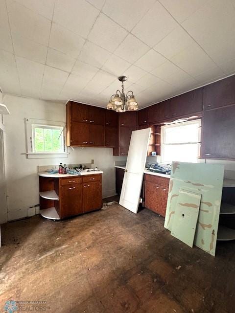 310 1st St SW, Mahnomen, MN 56557 - kitchen with open shelves, a chandelier, pendant lighting, and light countertops