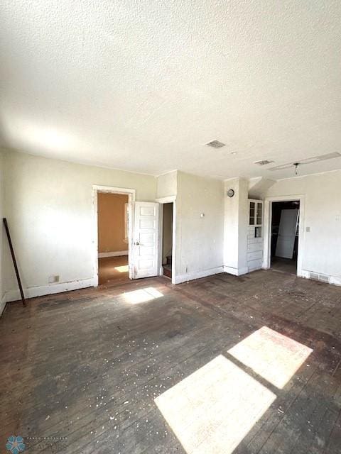 310 1st St SW, Mahnomen, MN 56557 - empty room with a textured ceiling and baseboards
