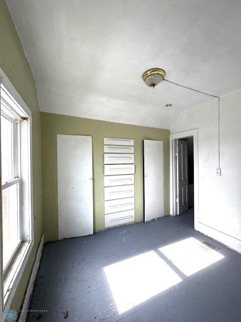 310 1st St SW, Mahnomen, MN 56557 - unfurnished bedroom featuring lofted ceiling