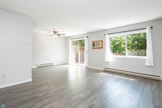 3050 18th St S, Fargo, ND 58103 - empty room featuring a baseboard heating unit, an AC wall unit, and wood finished floors