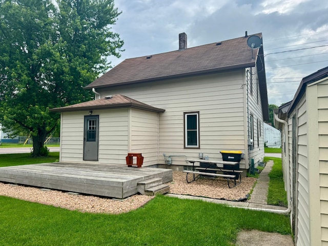 720 Fir Ave, Bird Island, MN 55310 - back of property with a deck, a shingled roof, and a yard