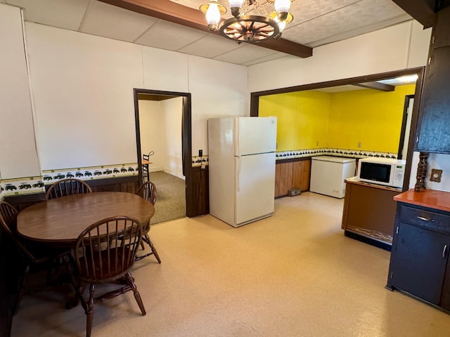 720 Fir Ave, Bird Island, MN 55310 - kitchen with white appliances, a chandelier, blue cabinetry, and light flooring