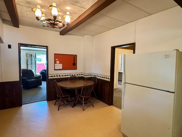 720 Fir Ave, Bird Island, MN 55310 - dining room with beamed ceiling, a chandelier, and wainscoting