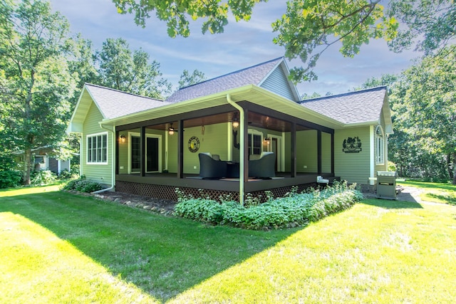 1069 134th St SW, Sylvan Twp, MN 56473 - view of side of property featuring a shingled roof, a lawn, and ceiling fan