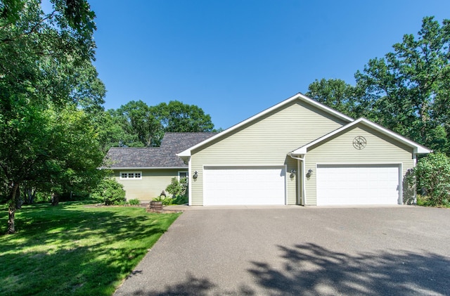 1069 134th St SW, Sylvan Twp, MN 56473 - ranch-style home with a front yard, an attached garage, and asphalt driveway