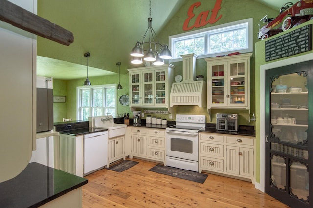 1069 134th St SW, Sylvan Twp, MN 56473 - kitchen with white appliances, lofted ceiling, range hood, a peninsula, and dark countertops