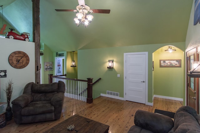 1069 134th St SW, Sylvan Twp, MN 56473 - living area with vaulted ceiling, hardwood / wood-style floors, a ceiling fan, and arched walkways