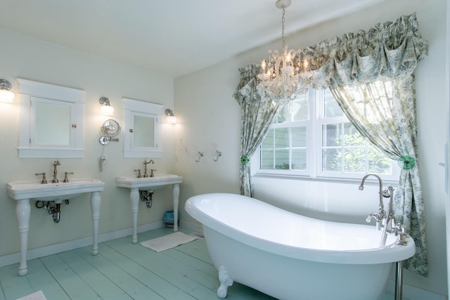 1069 134th St SW, Sylvan Twp, MN 56473 - full bath featuring a freestanding tub, a chandelier, and wood finished floors