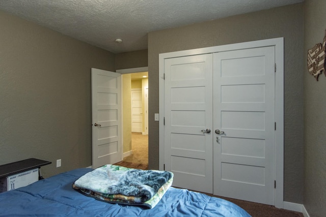1069 134th St SW, Sylvan Twp, MN 56473 - carpeted bedroom featuring a textured ceiling, a closet, and a textured wall