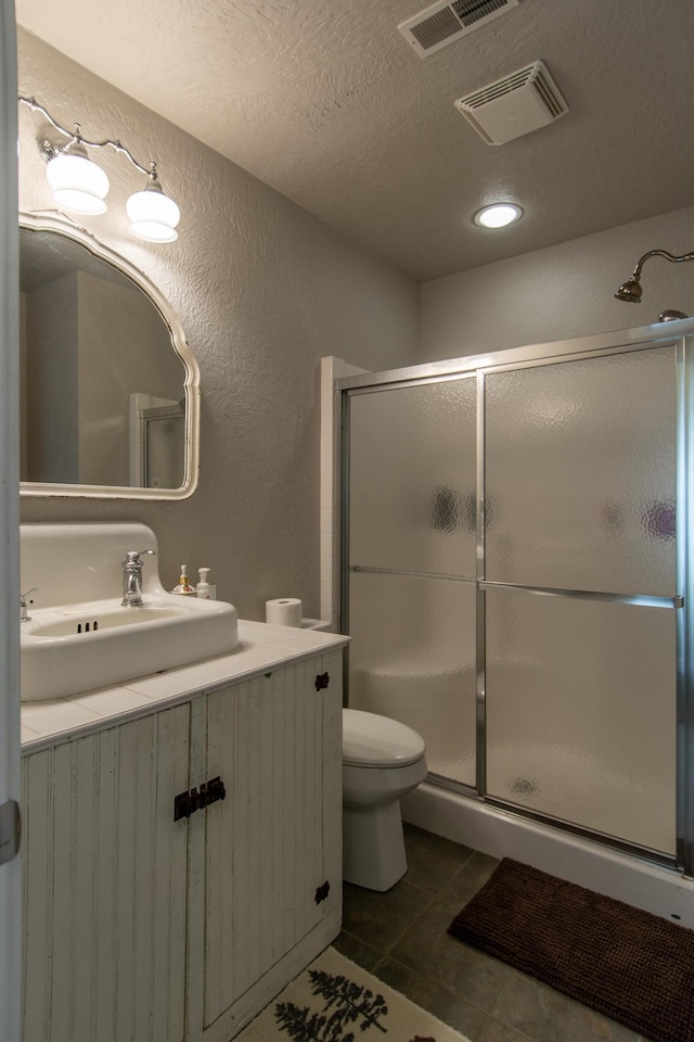 1069 134th St SW, Sylvan Twp, MN 56473 - bathroom featuring vanity, a stall shower, tile patterned flooring, a textured wall, and a textured ceiling