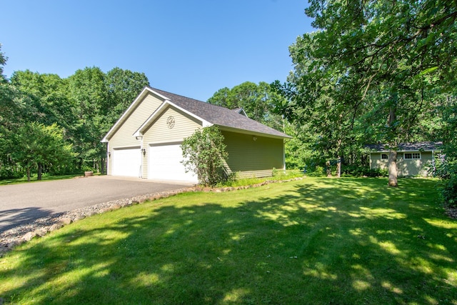 1069 134th St SW, Sylvan Twp, MN 56473 - view of home's exterior featuring driveway, a lawn, and an attached garage