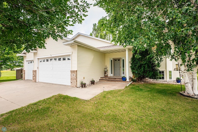 106 12th St NE, Barnesville, MN 56514 - view of front of property with a garage, concrete driveway, a front yard, and brick siding