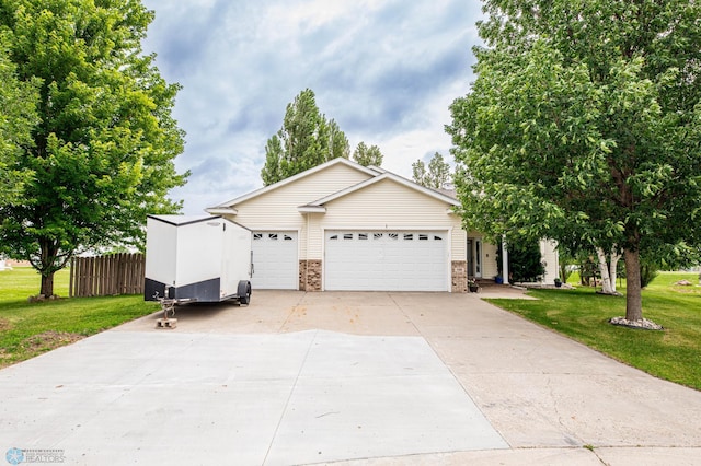106 12th St NE, Barnesville, MN 56514 - view of front of property with concrete driveway, an attached garage, and brick siding