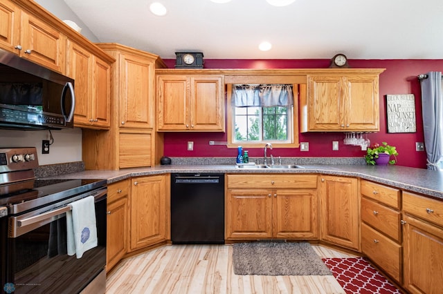 106 12th St NE, Barnesville, MN 56514 - kitchen with black dishwasher, electric range, light wood-type flooring, and brown cabinetry