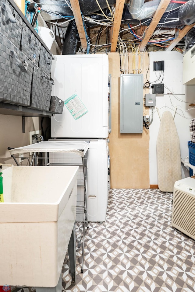 106 12th St NE, Barnesville, MN 56514 - unfinished basement with electric panel, stacked washing machine and dryer, and tile patterned floors