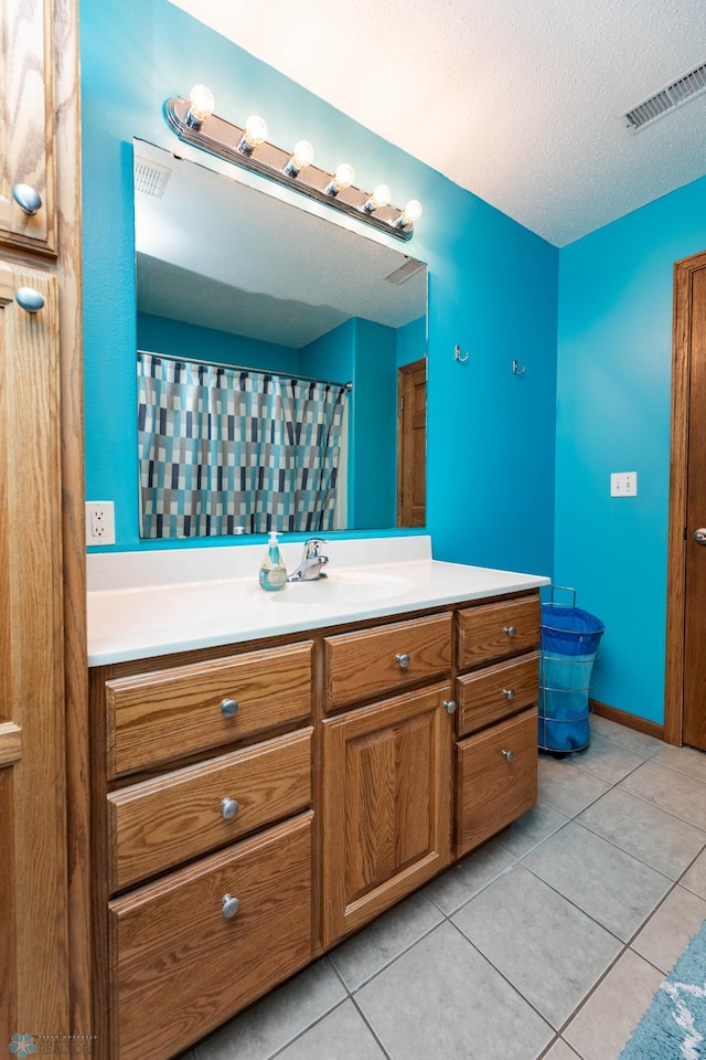 106 12th St NE, Barnesville, MN 56514 - bathroom featuring vanity, tile patterned flooring, and a textured ceiling