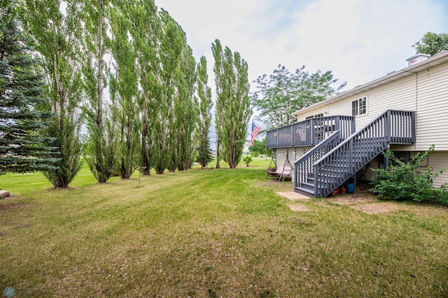 106 12th St NE, Barnesville, MN 56514 - view of grassy yard featuring stairs and a deck