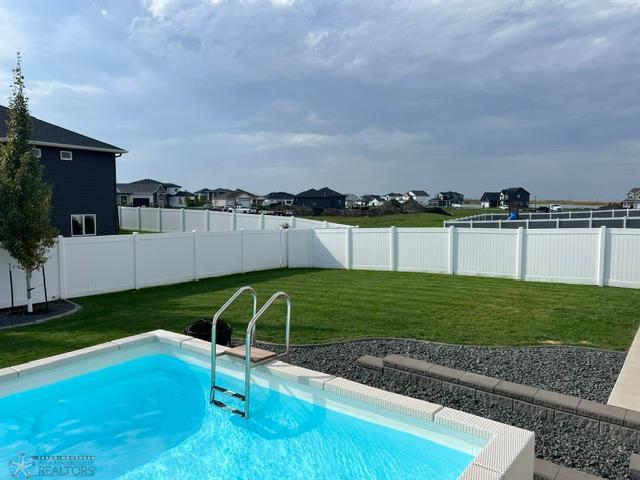 4701 11th St W, West Fargo, ND 58078 - view of pool with a fenced backyard and a residential view
