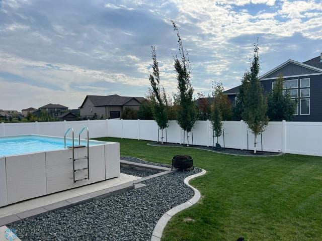 4701 11th St W, West Fargo, ND 58078 - fenced backyard featuring a fire pit