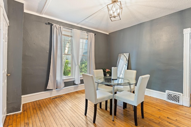 3114 Russell Ave N, Minneapolis, MN 55411 - dining space with hardwood / wood-style floors and a chandelier