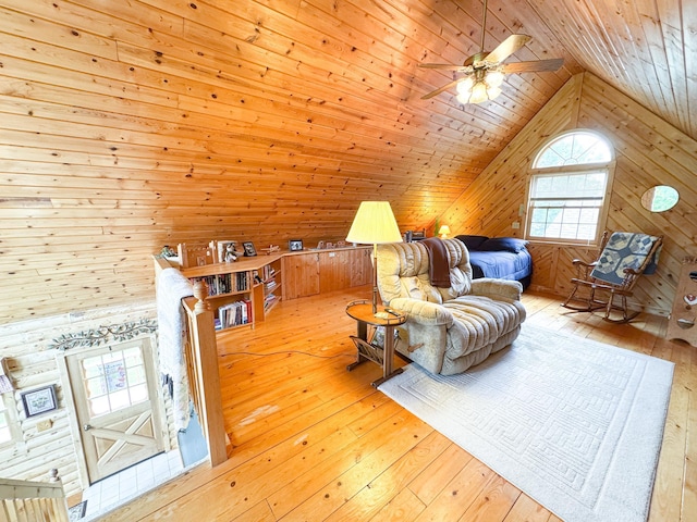34002 Fiske View Dr, Underwood, MN 56586 - living area with wood walls, wood-type flooring, lofted ceiling, wooden ceiling, and a ceiling fan