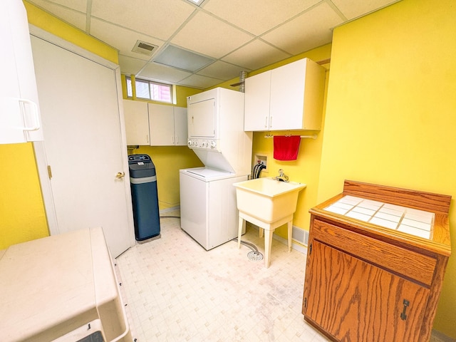 34002 Fiske View Dr, Underwood, MN 56586 - laundry room with stacked washer / drying machine, light floors, and cabinet space