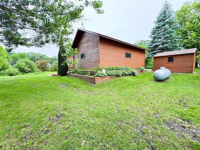 34002 Fiske View Dr, Underwood, MN 56586 - view of home's exterior featuring a garden, a lawn, and an outdoor structure