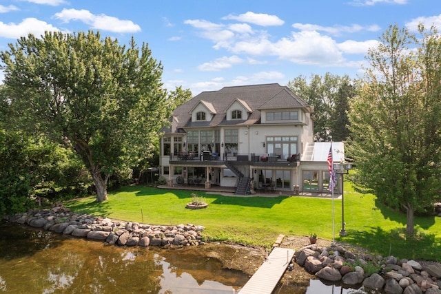 22620 Hayward Ave N, Forest Lake, MN 55025 - back of property featuring an outdoor fire pit, a patio area, a deck with water view, a lawn, and stairs