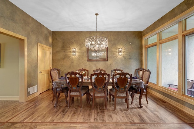 22620 Hayward Ave N, Forest Lake, MN 55025 - dining space with wood finished floors, a chandelier, and healthy amount of natural light