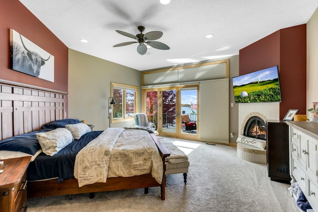 22620 Hayward Ave N, Forest Lake, MN 55025 - bedroom featuring access to exterior, a tiled fireplace, recessed lighting, light colored carpet, and ceiling fan