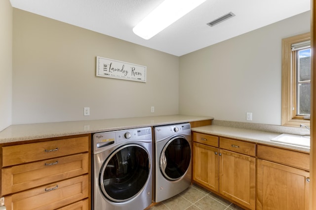 22620 Hayward Ave N, Forest Lake, MN 55025 - laundry room featuring washing machine and clothes dryer, cabinet space, and light tile patterned floors