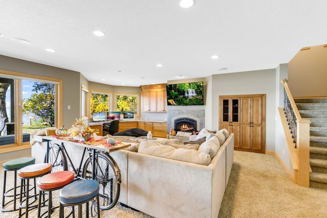 22620 Hayward Ave N, Forest Lake, MN 55025 - living area featuring stairway, recessed lighting, a warm lit fireplace, and light colored carpet