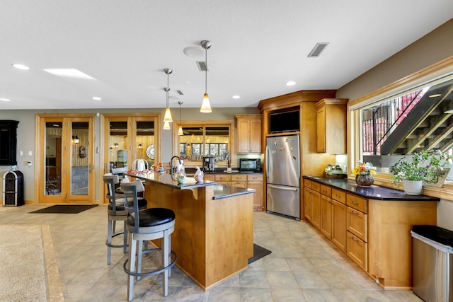 22620 Hayward Ave N, Forest Lake, MN 55025 - kitchen with freestanding refrigerator, dark countertops, black microwave, plenty of natural light, and recessed lighting