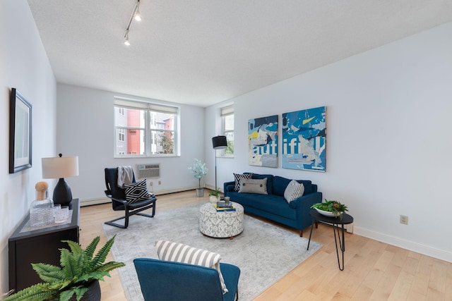 215 7th St NE Unit 205, Minneapolis, MN 55413 - living area featuring a wall unit AC, wood finished floors, and rail lighting