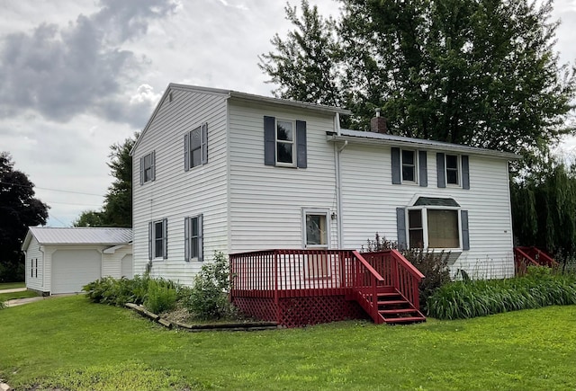 108 Johnson St NE, Brownsdale, MN 55918 - rear view of property with a deck, a yard, a garage, and a chimney