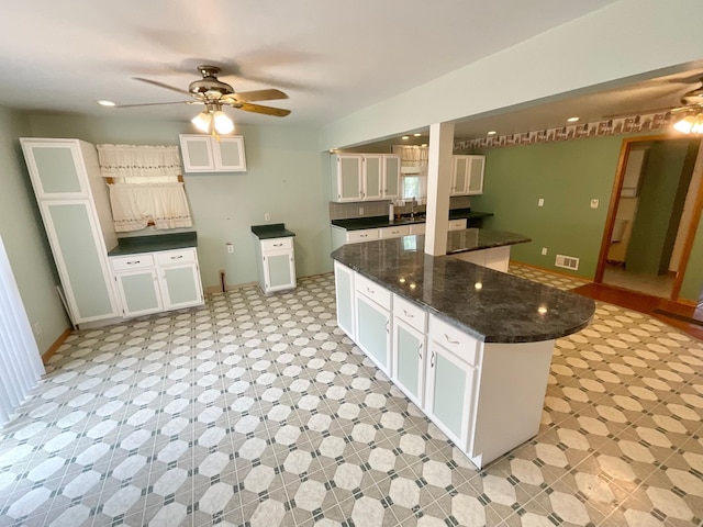108 Johnson St NE, Brownsdale, MN 55918 - kitchen with ceiling fan and white cabinets