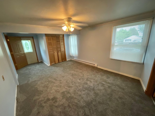 108 Johnson St NE, Brownsdale, MN 55918 - unfurnished bedroom with a baseboard radiator, carpet floors, ornamental molding, a closet, and a ceiling fan